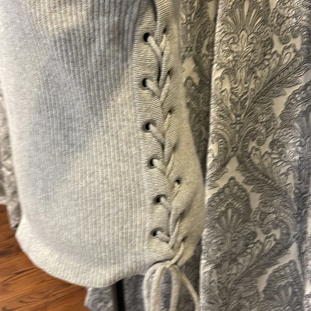 Gray crewneck sweater with lace up detail